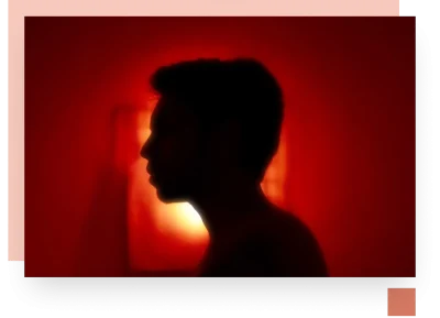 Outline shadow of teenage boy on angry red background