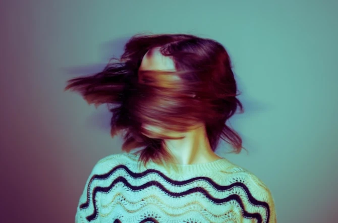 Teen shaking head in motion blur