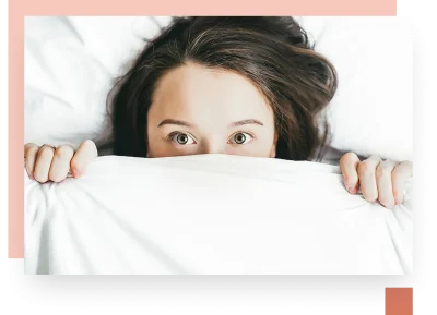 Teen hiding behind white bed duvet