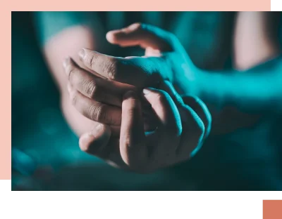 Hands clasped in dark light
