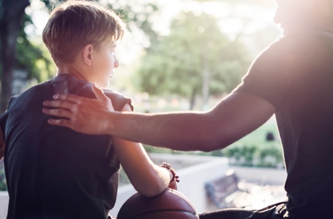 Parent patting shoulder of teen