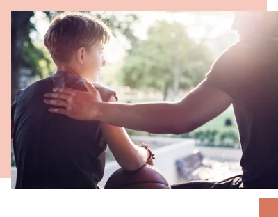 Parent patting shoulder of teen