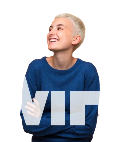 teenager looking confidently with blonde short cropped hair and blue sweater surrounded by large TMH letter blocks