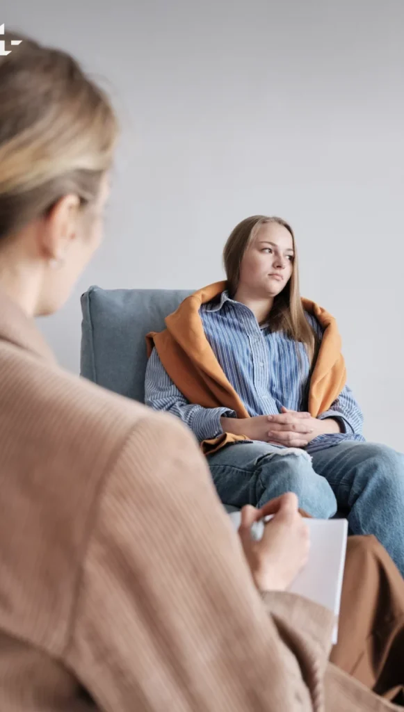 female therapist and teen in neutral room