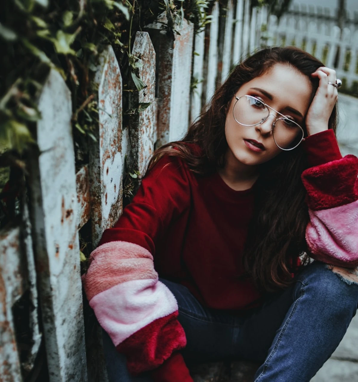 Young-girl-in-red-pink-sweater-sat-by-gate