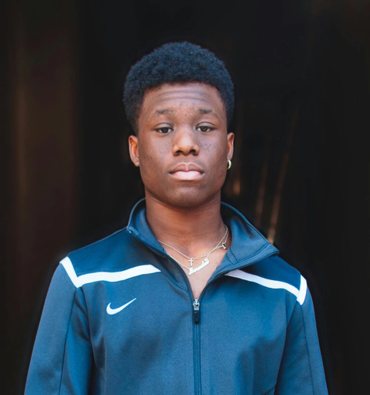 Young-male-in-sports-jacket-black-background