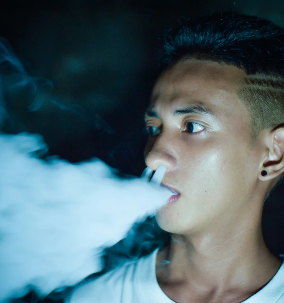 boy smoking at night