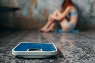 Young girl huddled in corner in distress