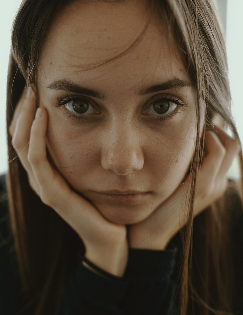 woman doing chin gesture while taking photo