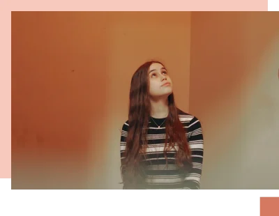 Teenage girl anxiously looking up with red background